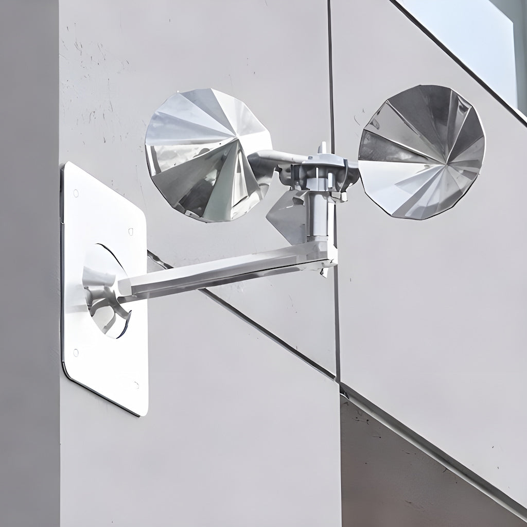 Ecobarbet™ spinning bird repeller mounted on a vertical concrete wall. Shows the adjustable 90-degree pole bend for versatile installation.