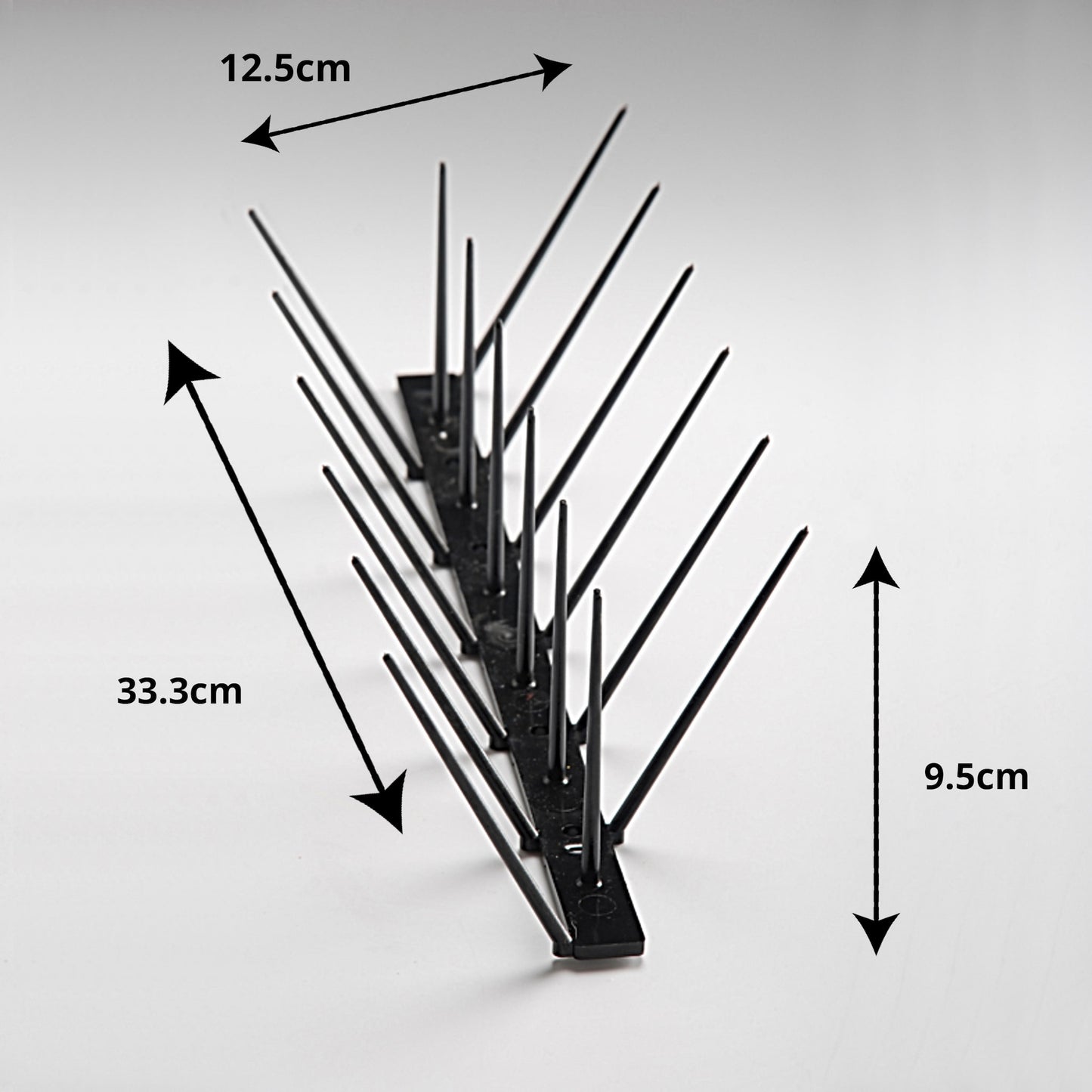 A diagram showing the Ecogreen black bird spike dimensions: 33cm length, 9.5cm height, 12cm top width, and 2cm base width.