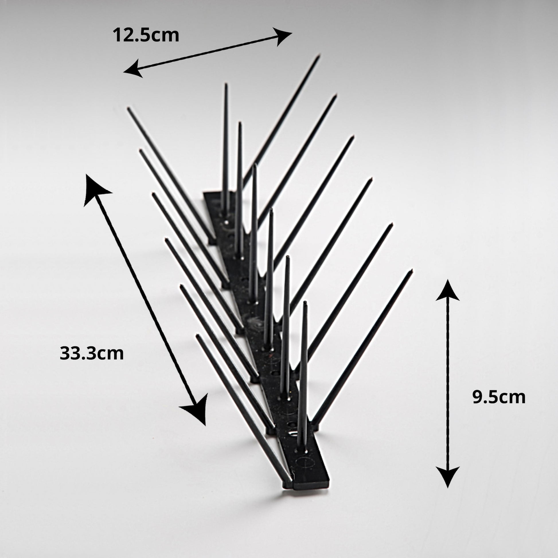 A diagram showing the Ecogreen black bird spike dimensions: 33cm length, 9.5cm height, 12cm top width, and 2cm base width.